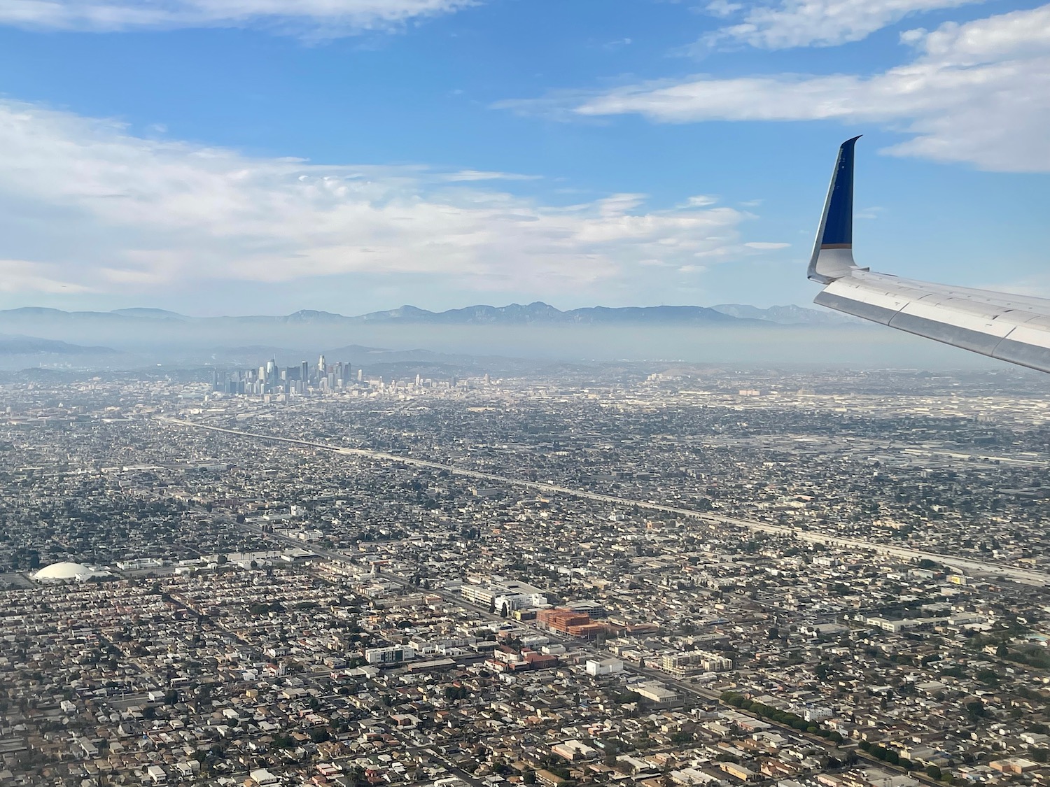 an airplane wing over a city