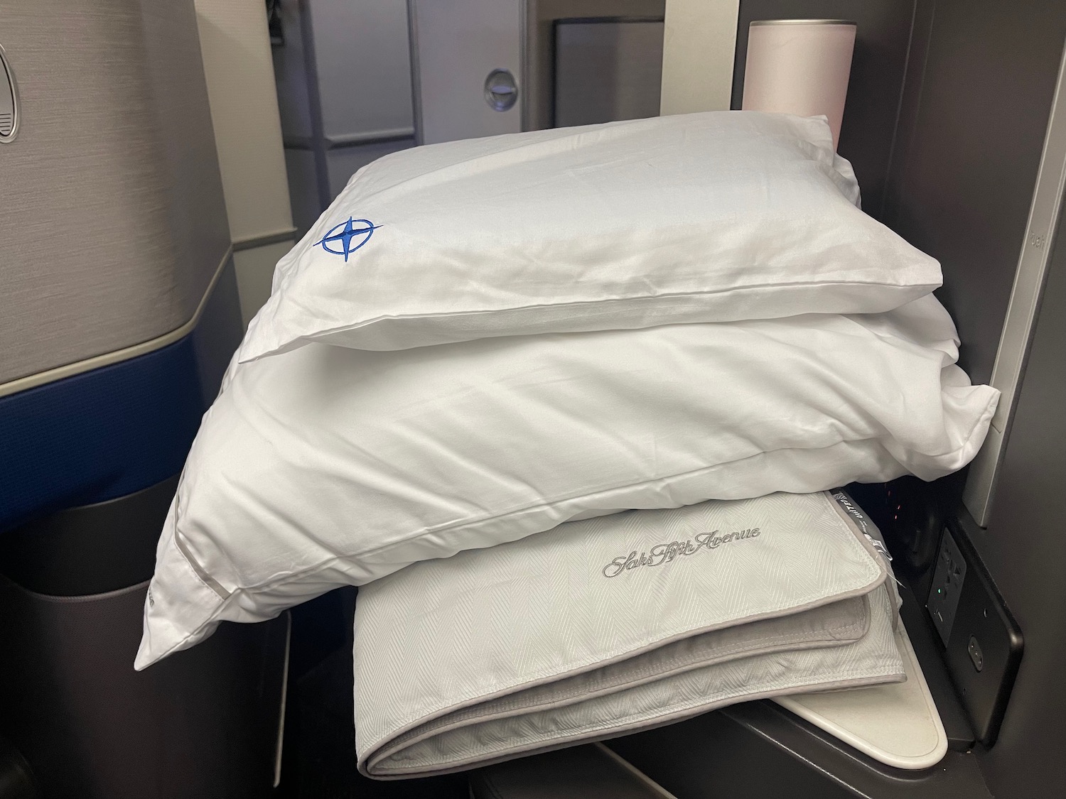 a stack of white pillows on a plane