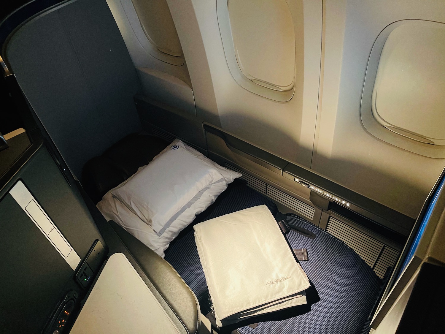 a bed with pillows in an airplane