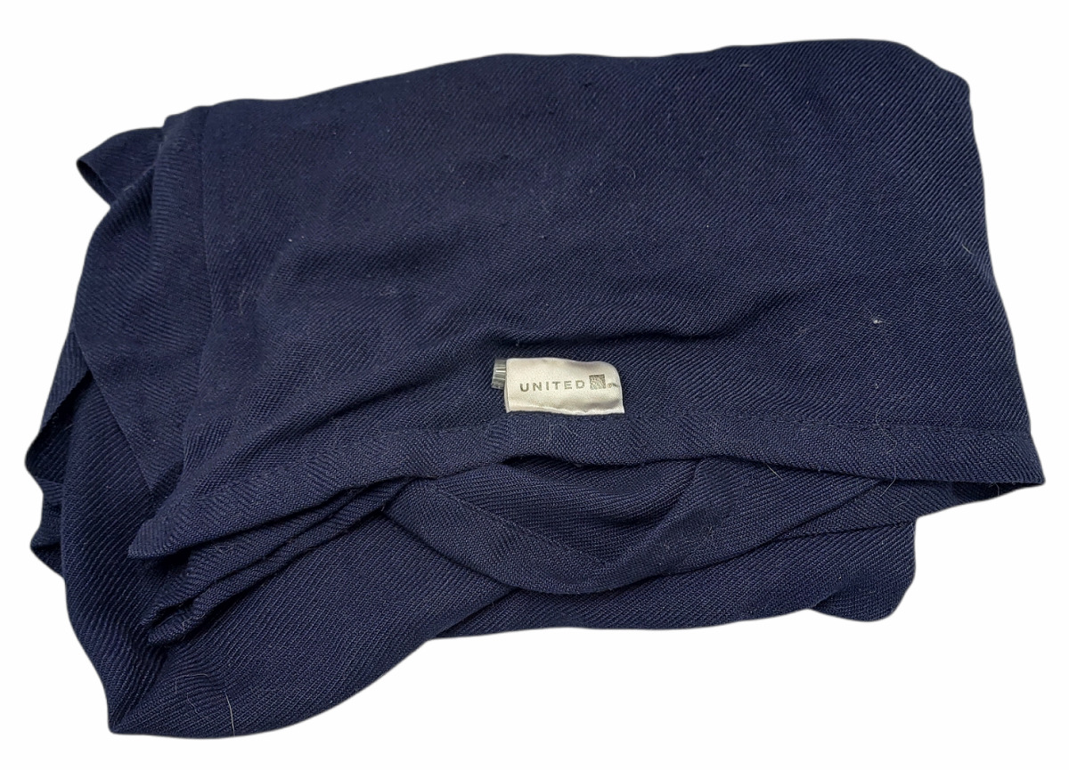 a folded blue blanket with a white label