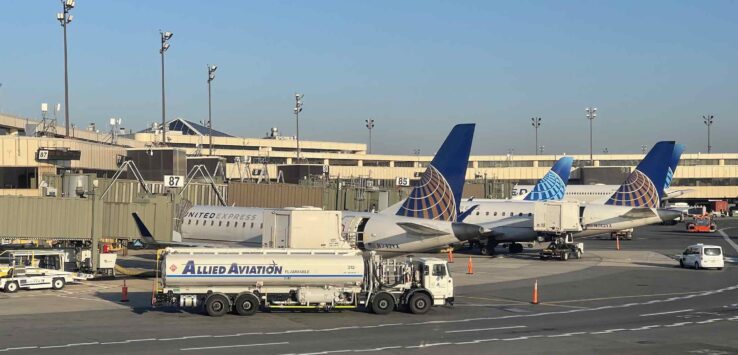 a group of airplanes parked on a runway