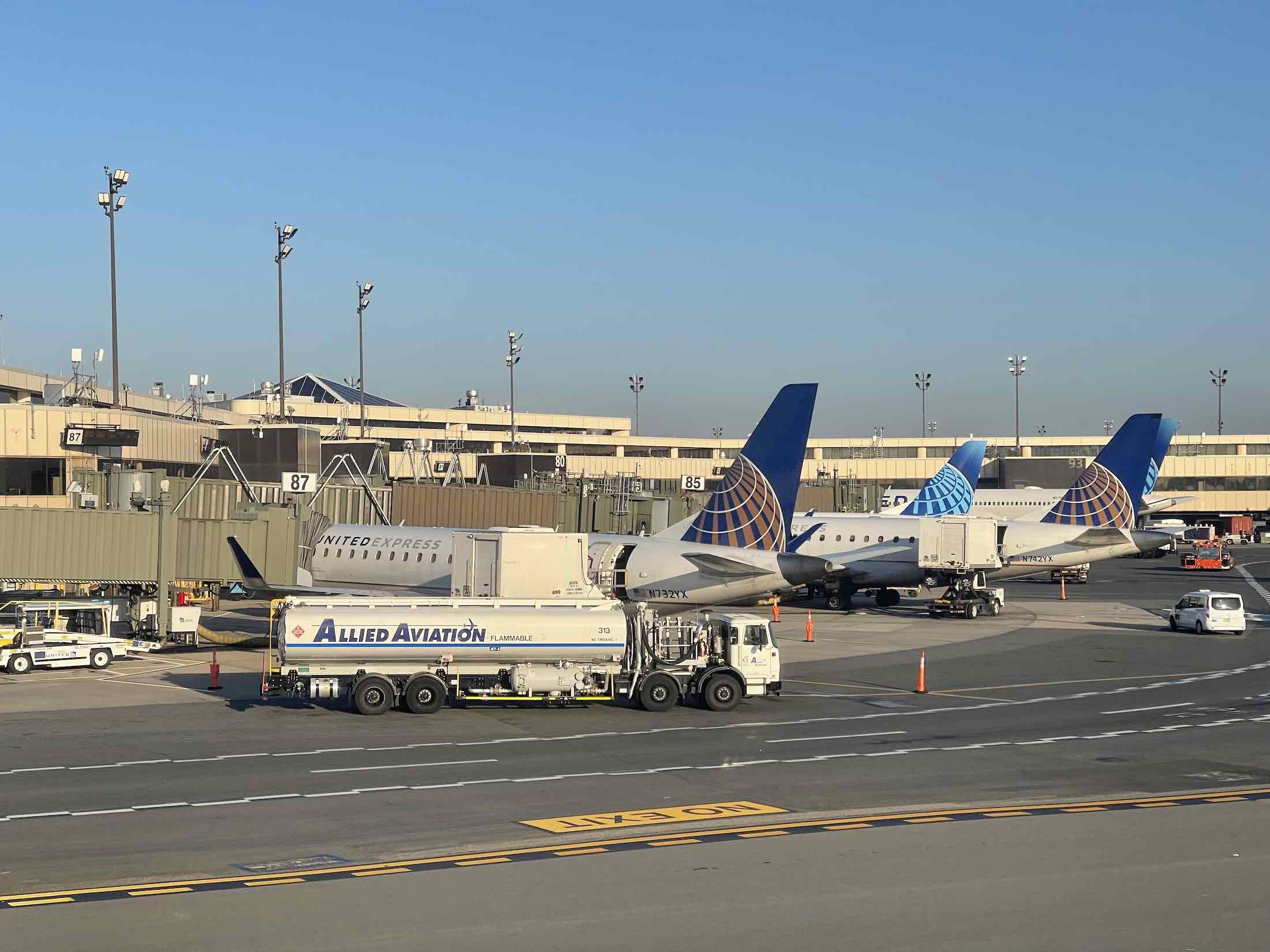 a group of airplanes parked on a runway