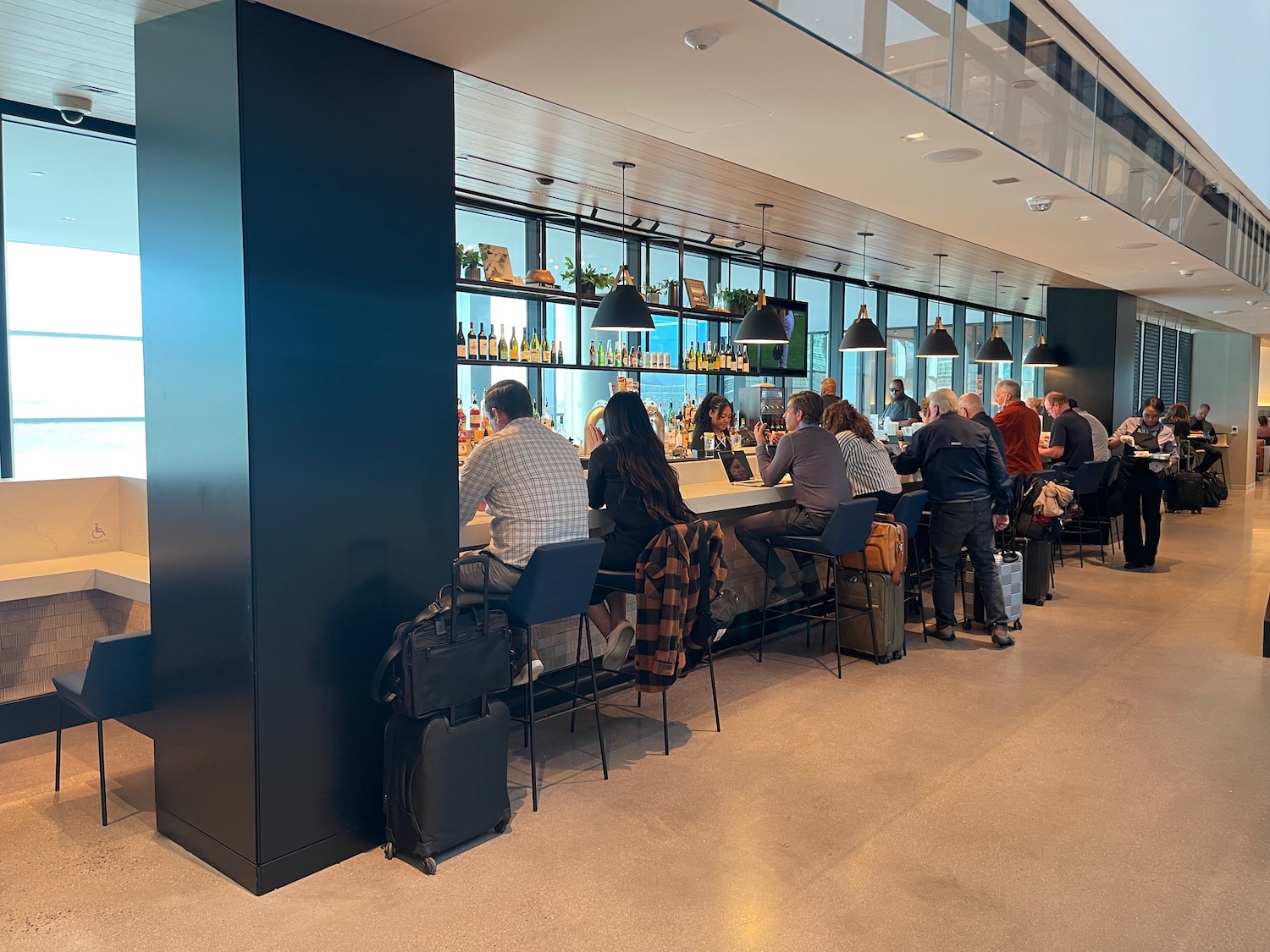 a group of people sitting at a bar