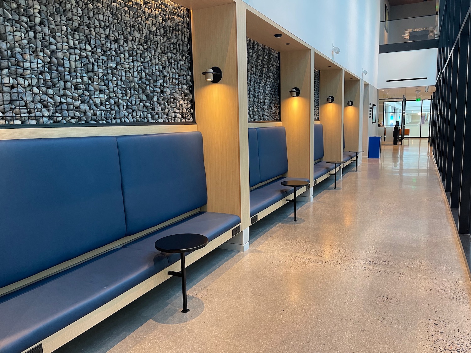 a row of blue benches in a hallway