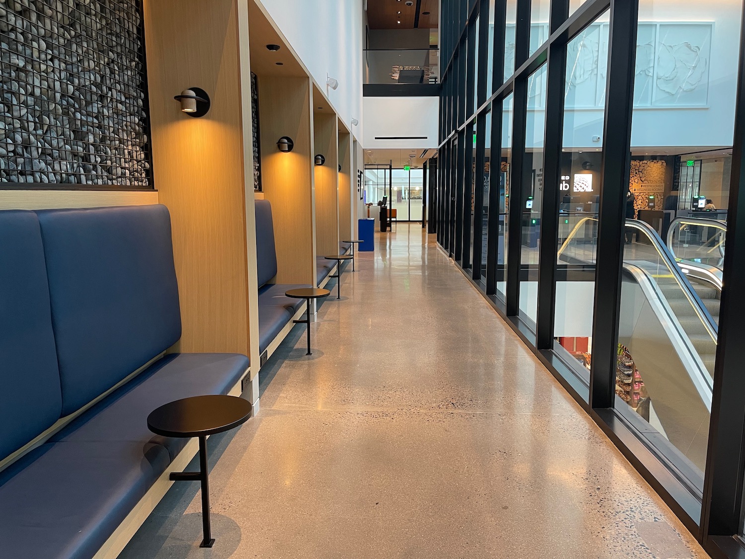 a long hallway with benches and windows