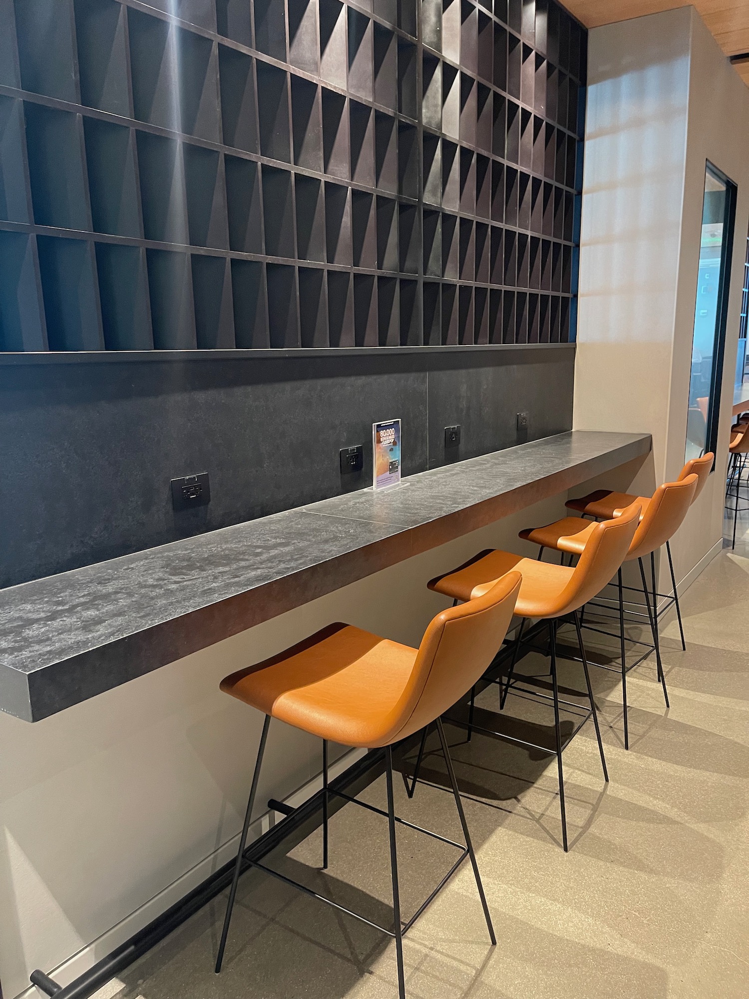 a bar with chairs and a shelf