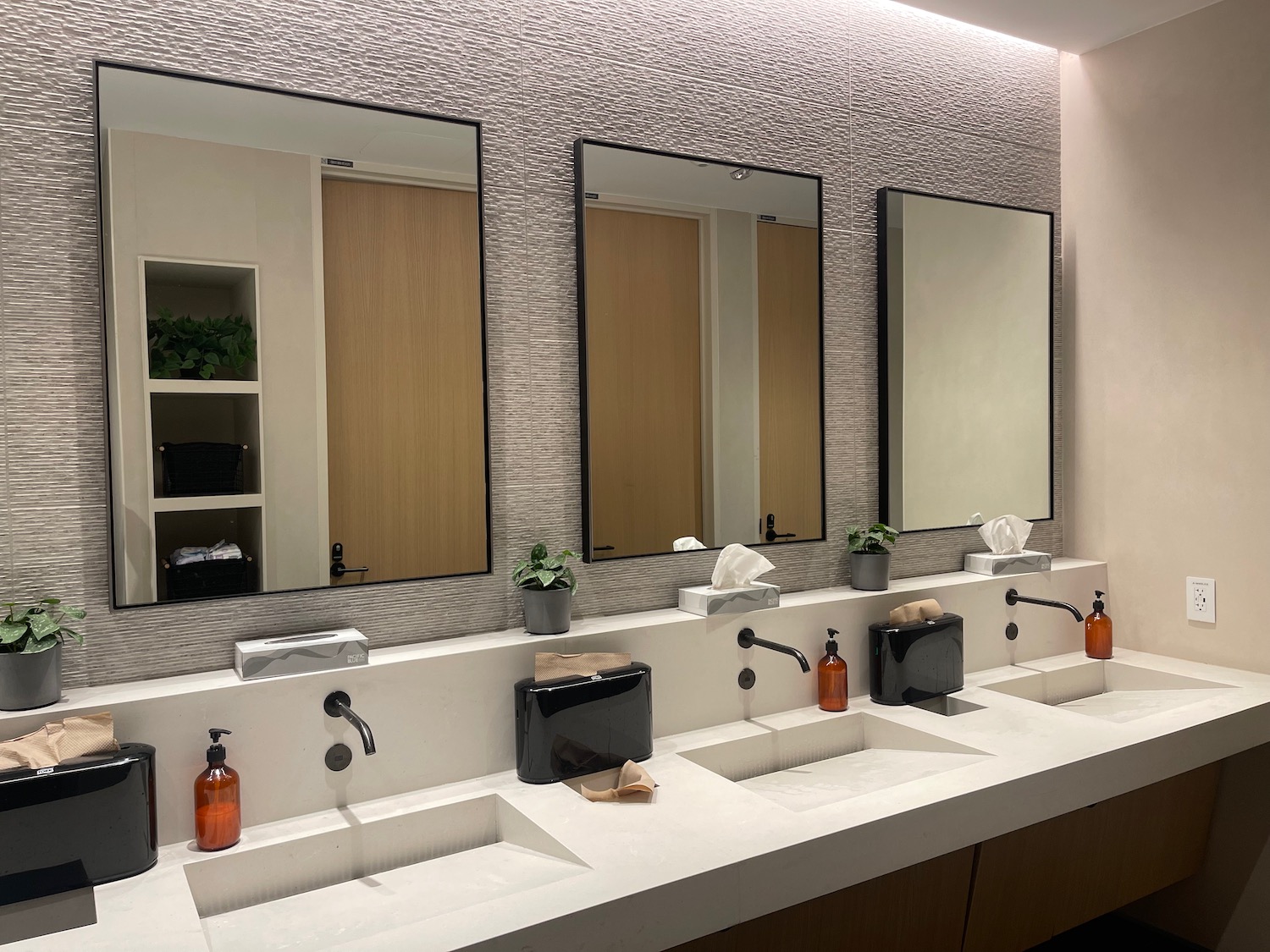 a bathroom with sinks and mirrors