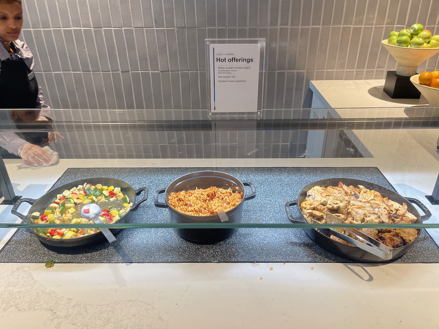 a group of pans with food in a glass case
