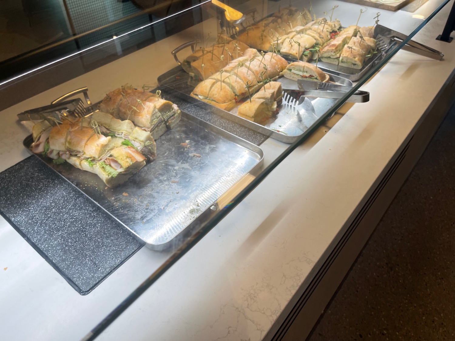 sandwiches on a tray in a glass case