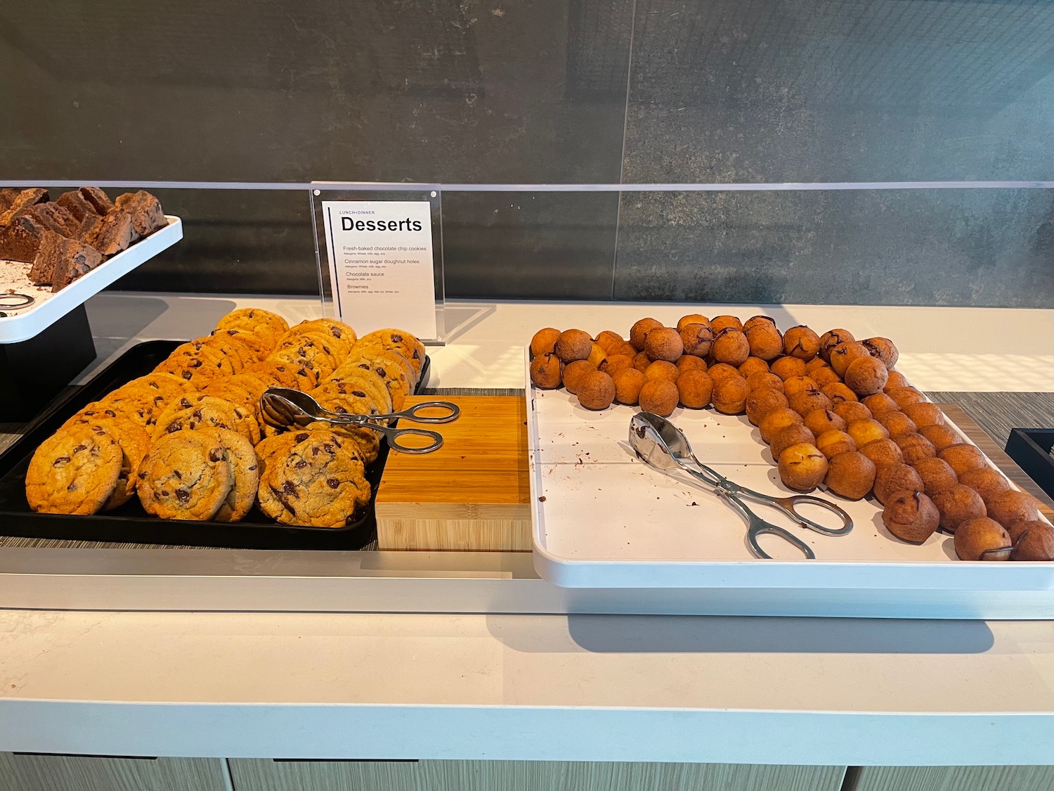 a tray of cookies and desserts on a counter