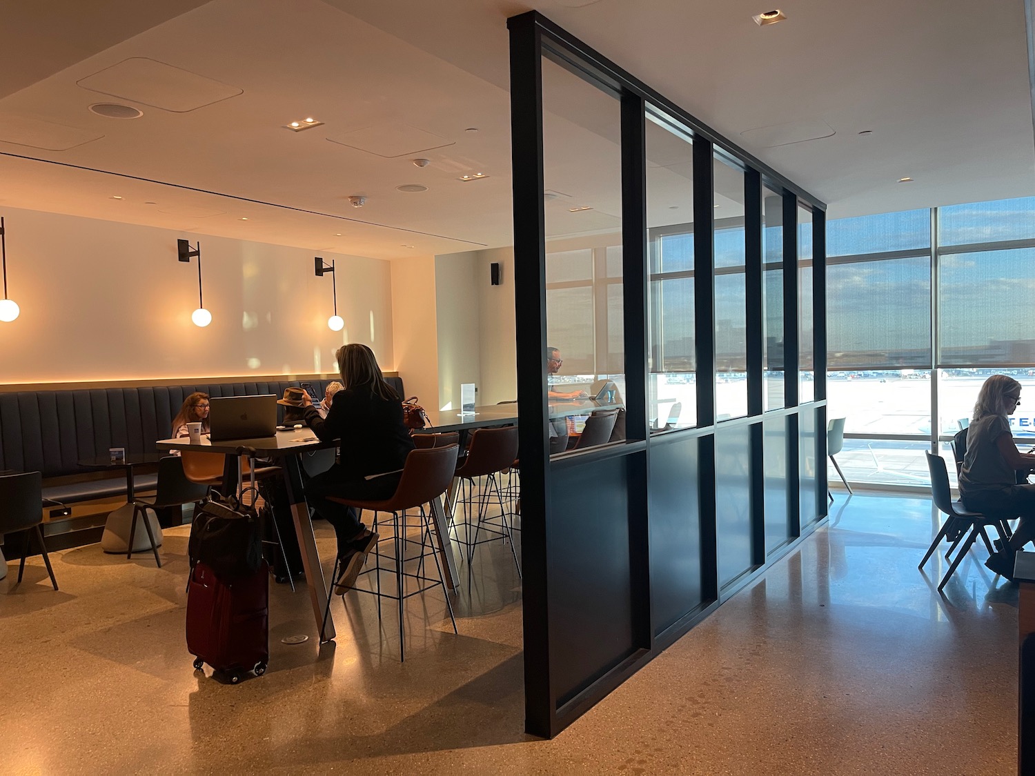 a room with a table and chairs with a couple of people sitting at tables