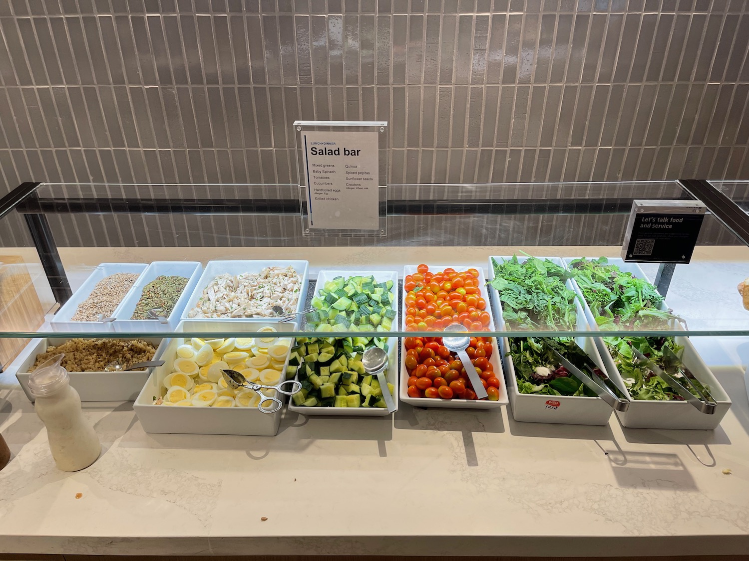 a salad bar with different salads in containers