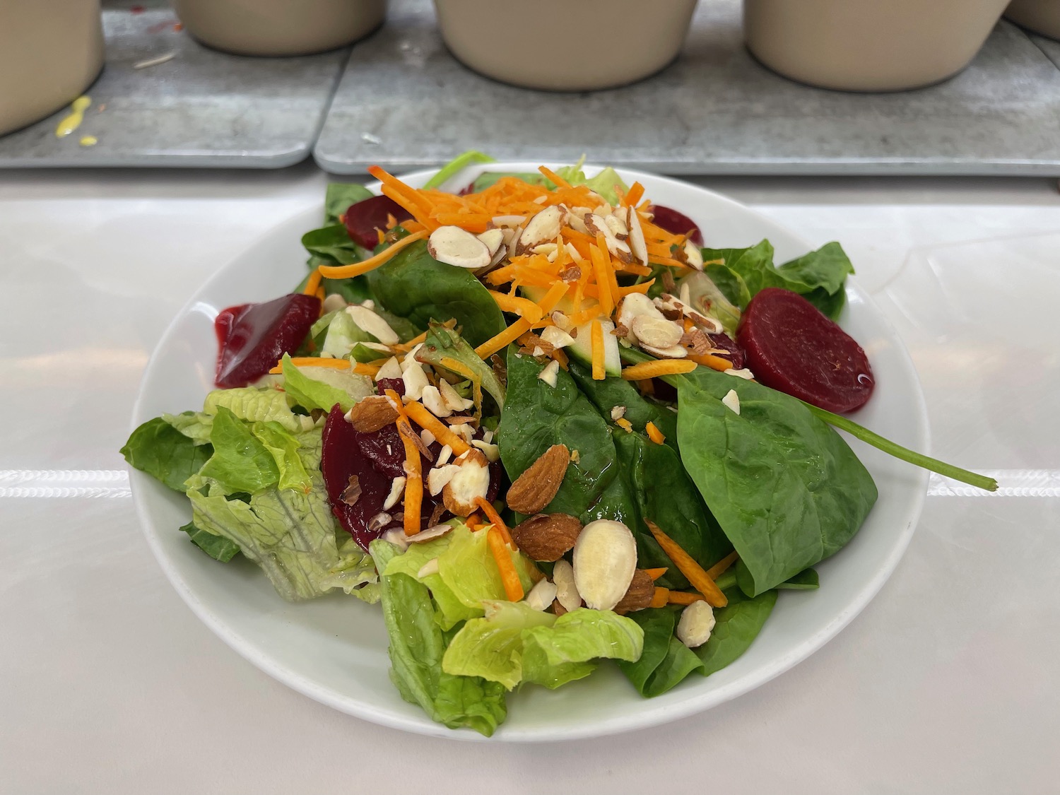 a plate of salad with nuts and vegetables