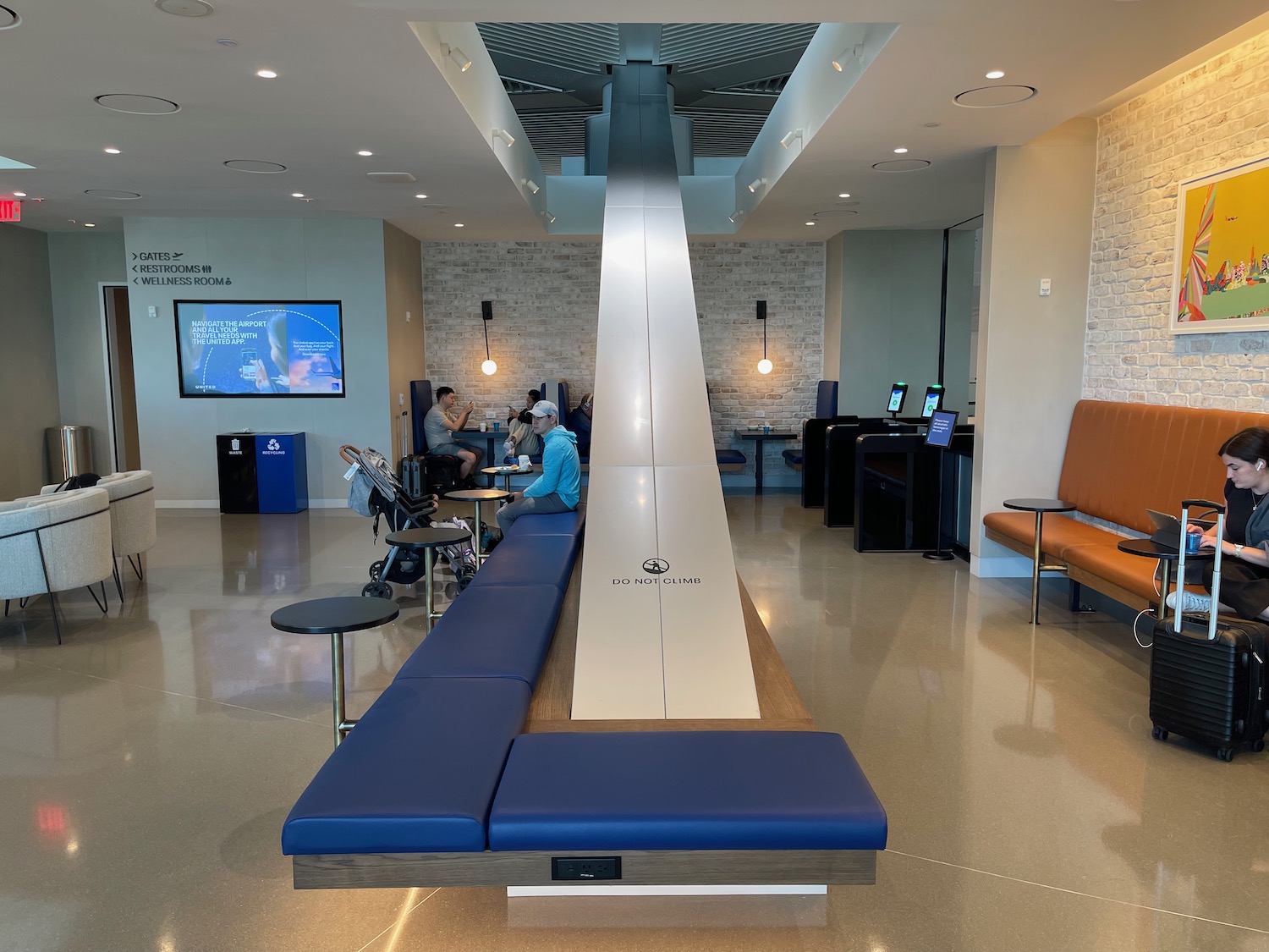 people sitting in a room with a long metal object