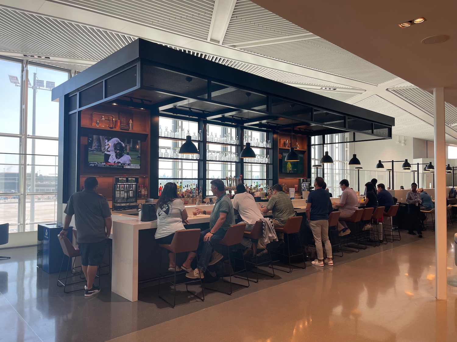 a group of people sitting at a bar