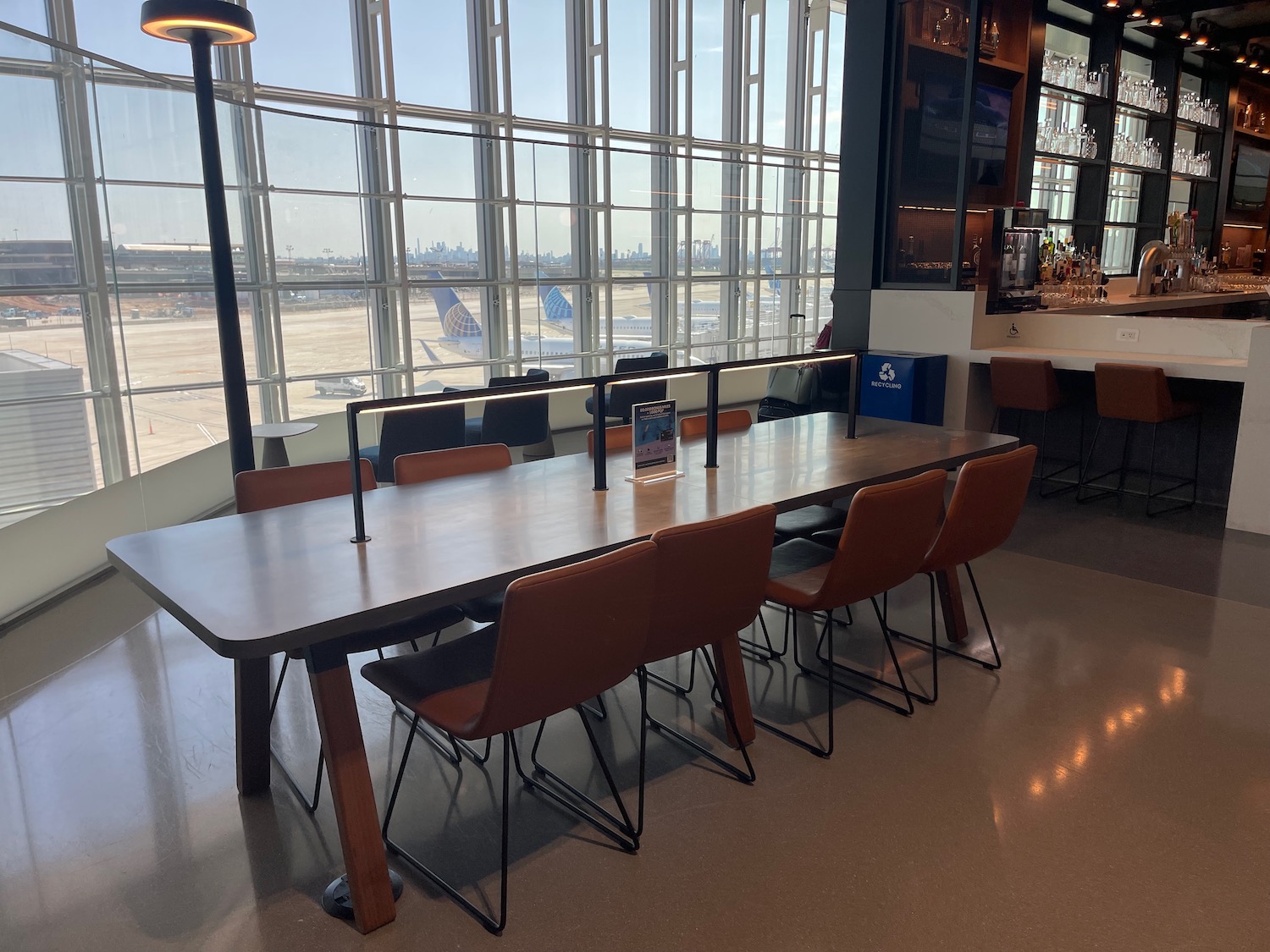 a table with chairs in a room with windows