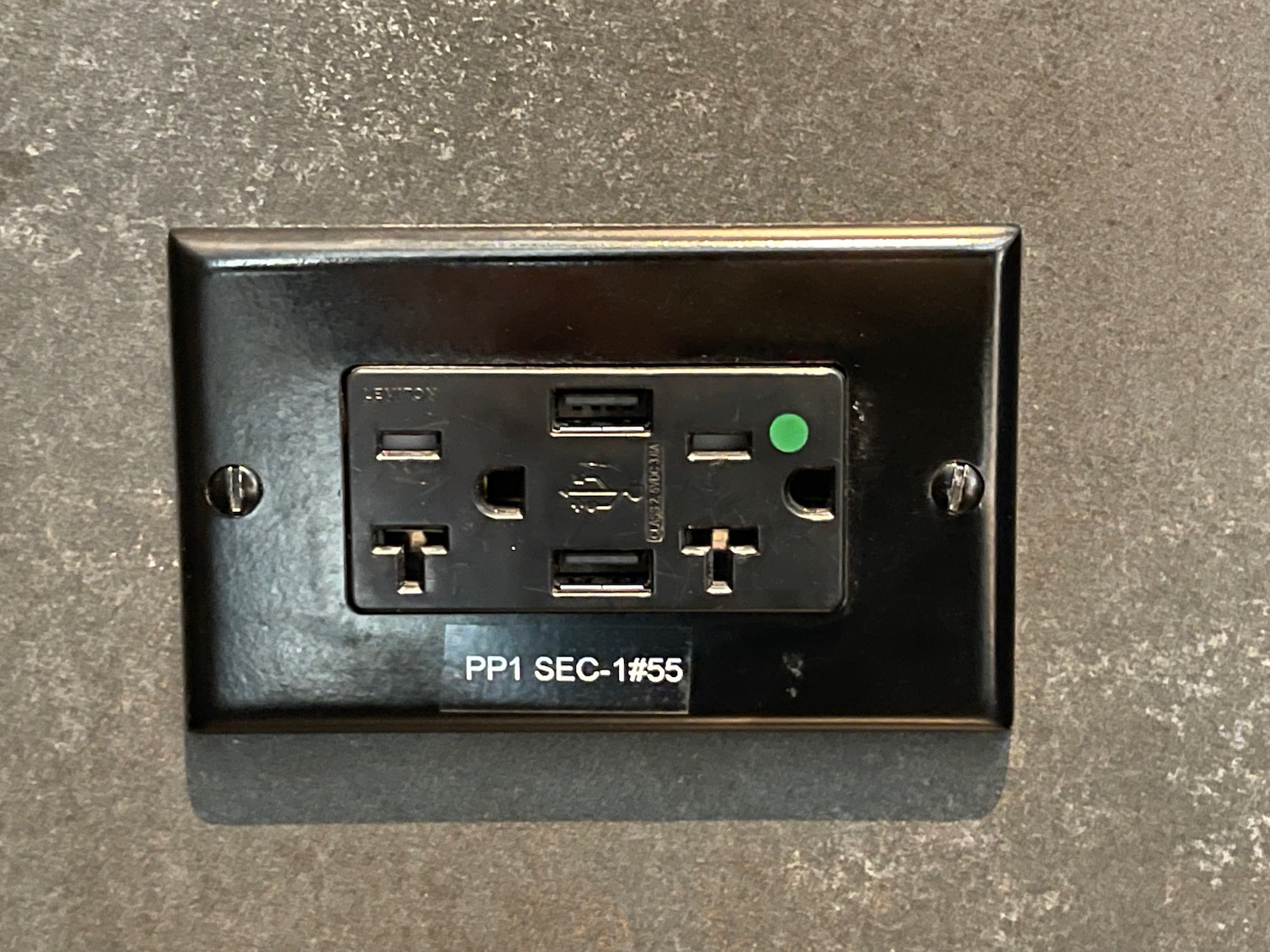 a black outlet with a green and white text