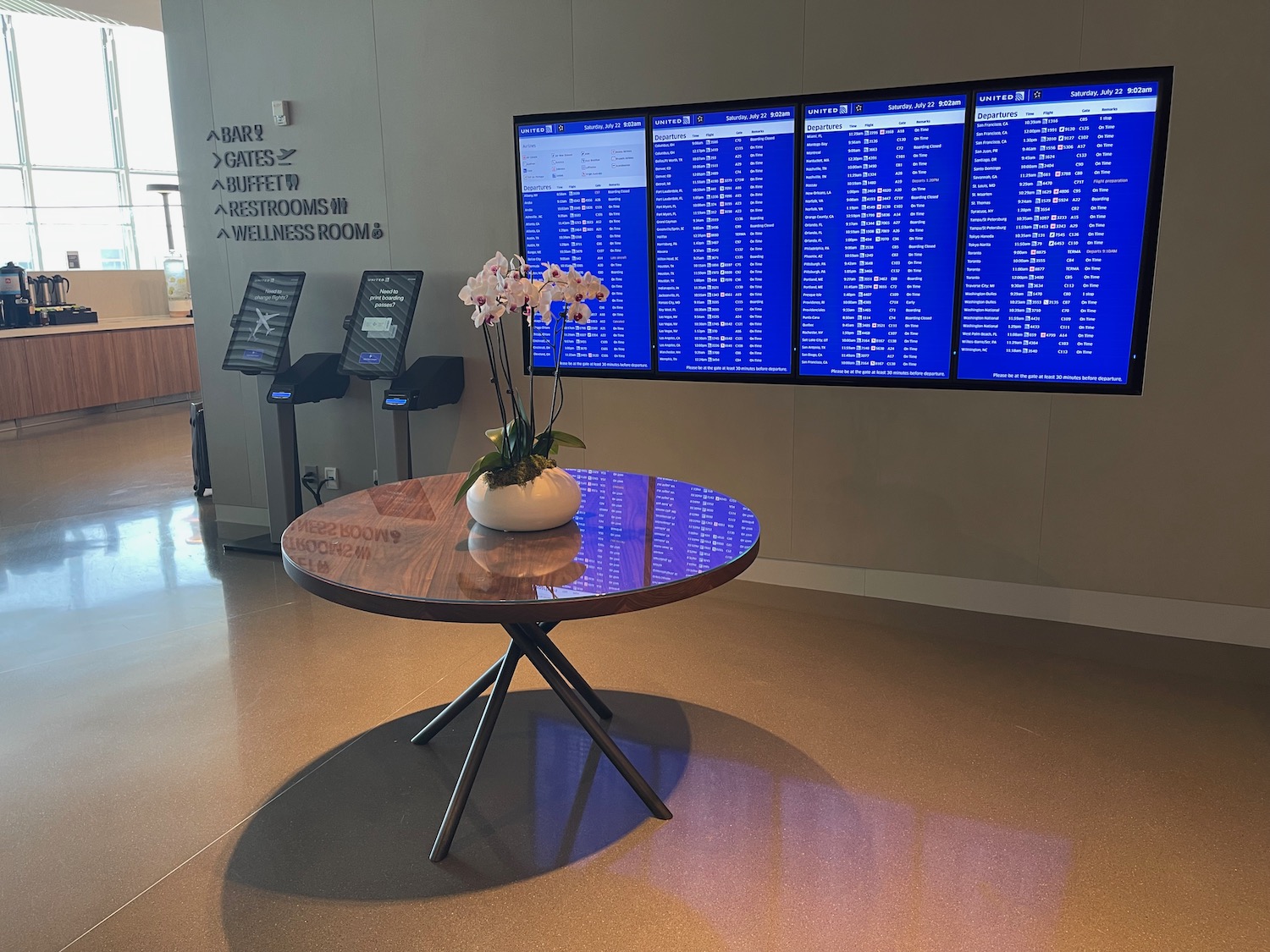 a table with flowers on it and a screen with blue text