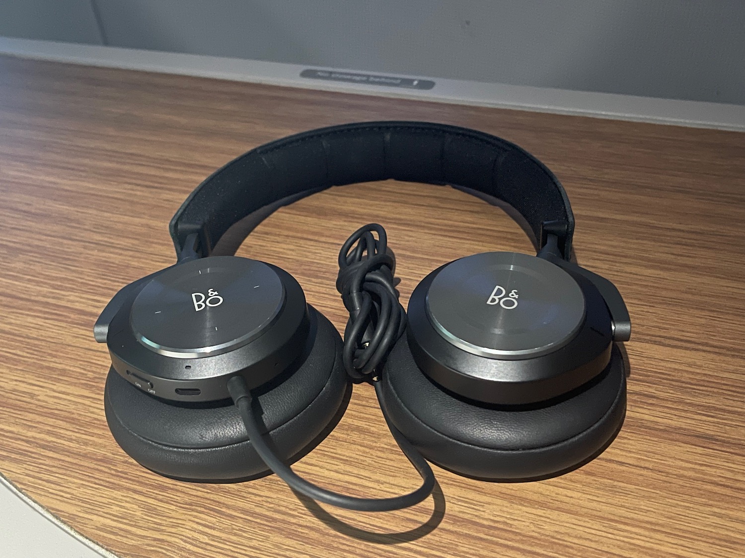 a pair of black headphones on a wood surface