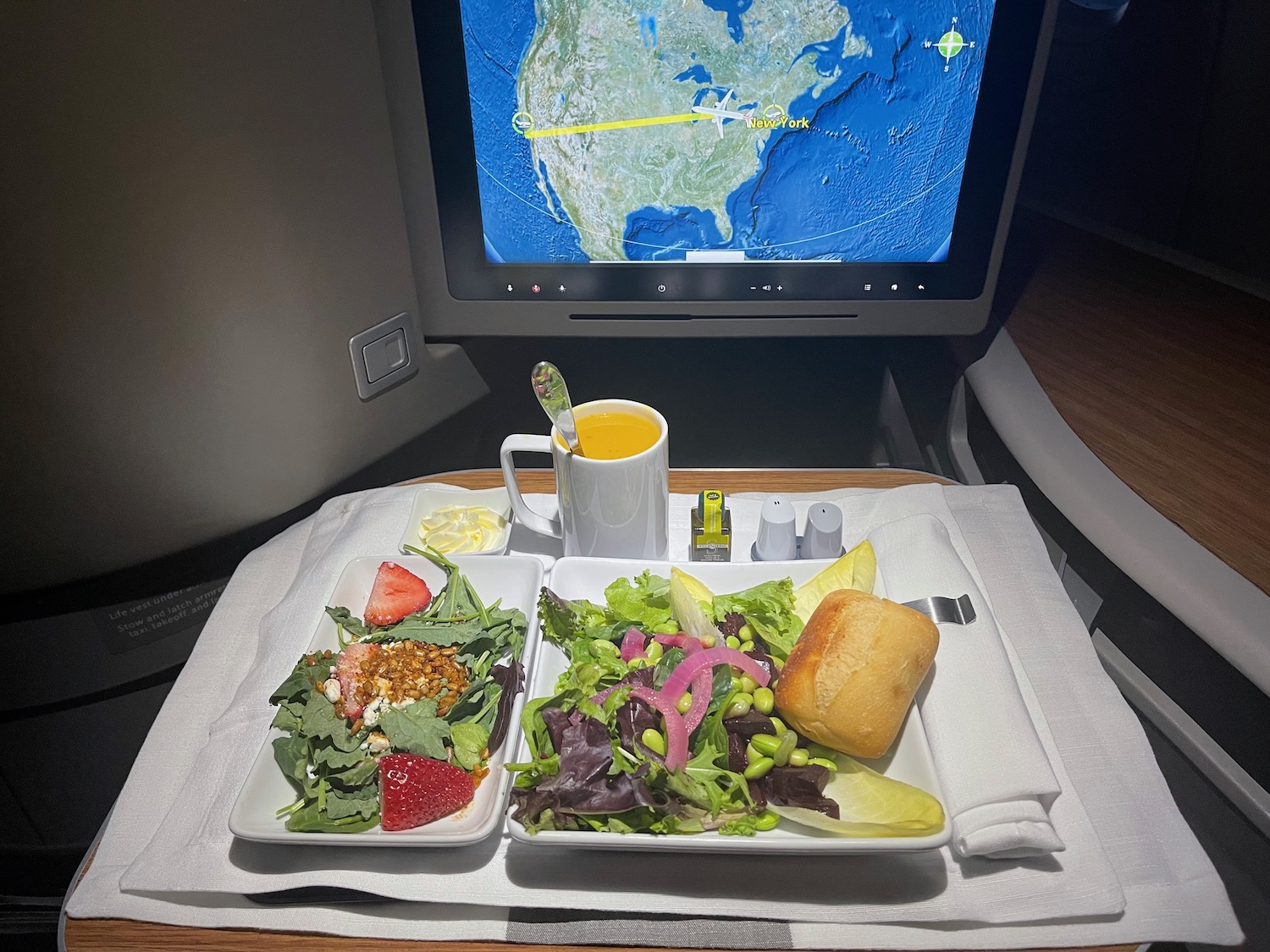 a plate of food on a table with a television screen