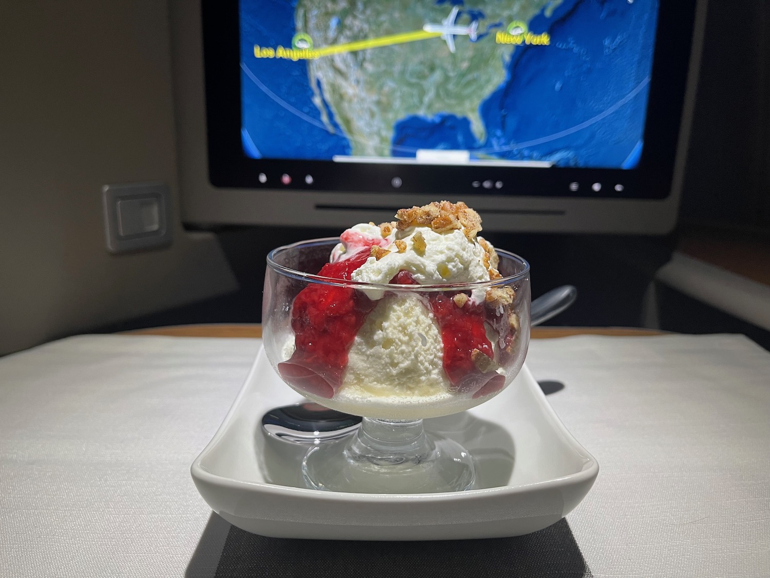 a bowl of ice cream with a television in the background