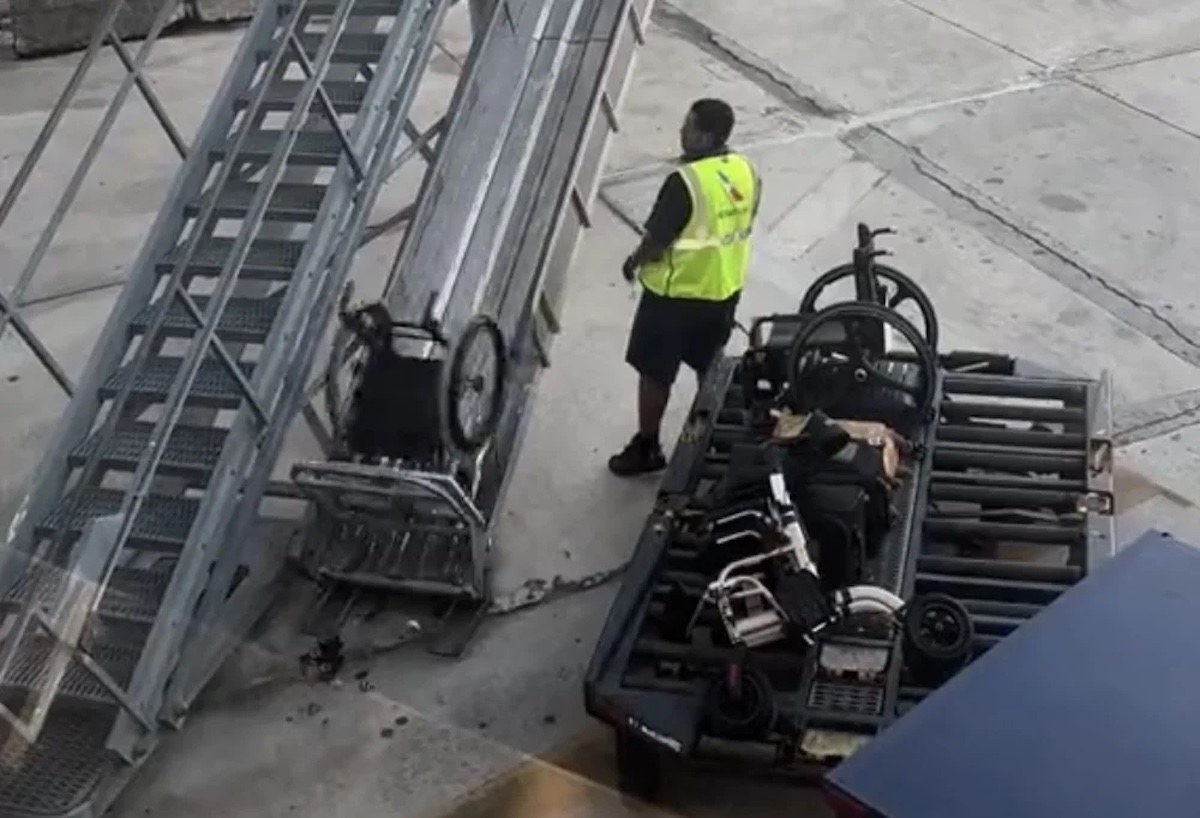 a man standing next to a wheelchair