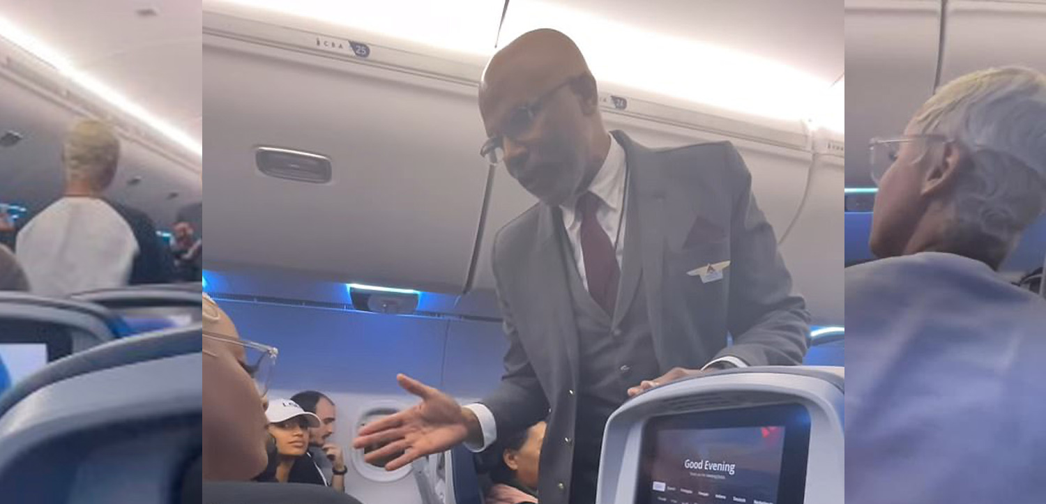 a man in a suit and tie standing in an airplane