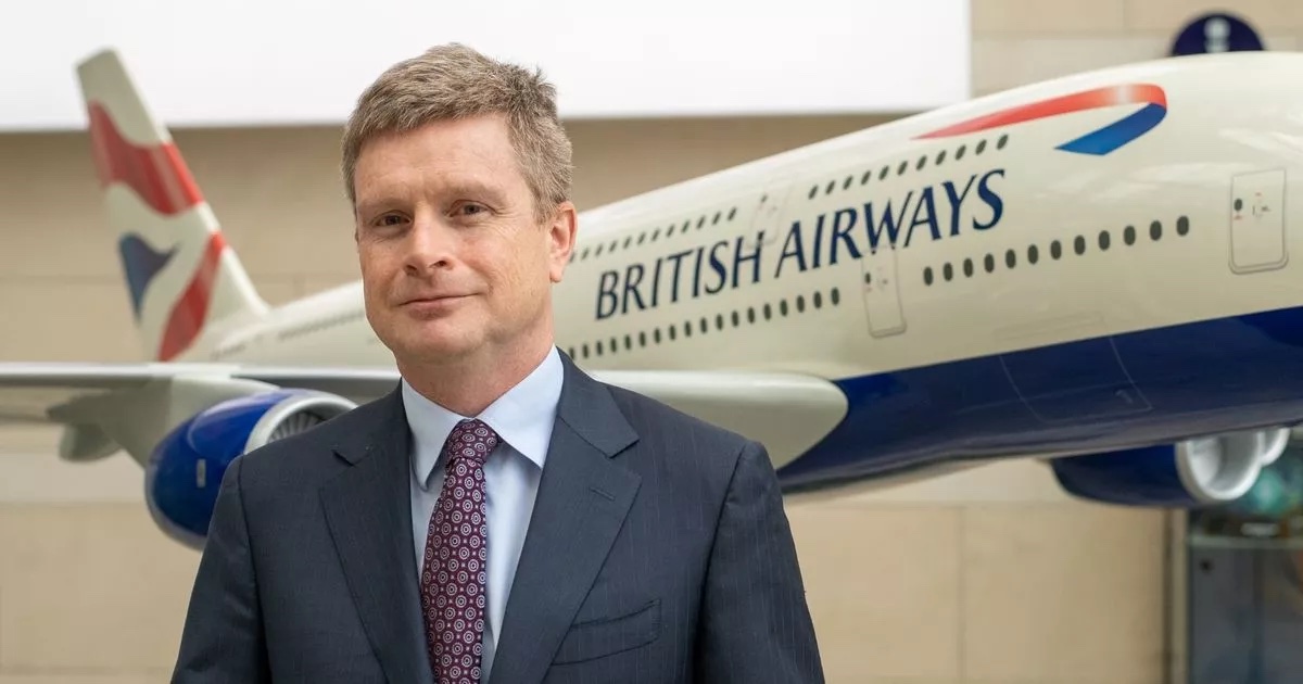 a man in a suit and tie standing in front of a plane