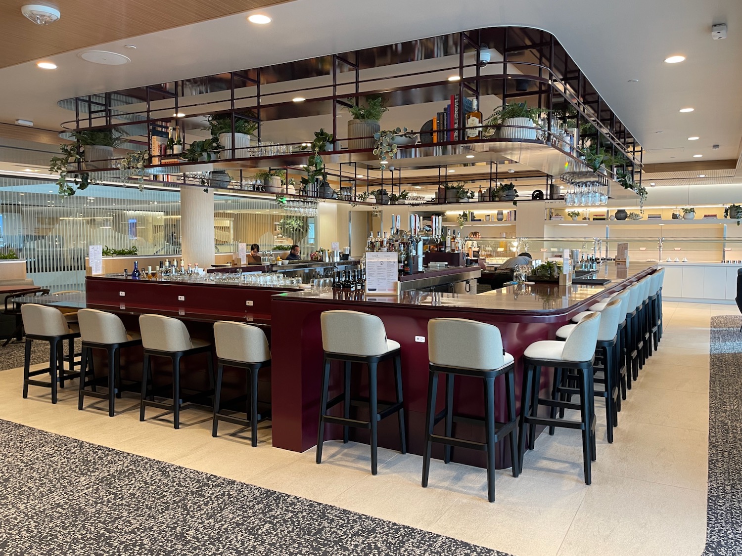 a bar with chairs and a shelf