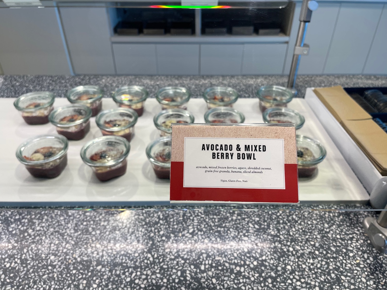 a sign on a table with bowls of food