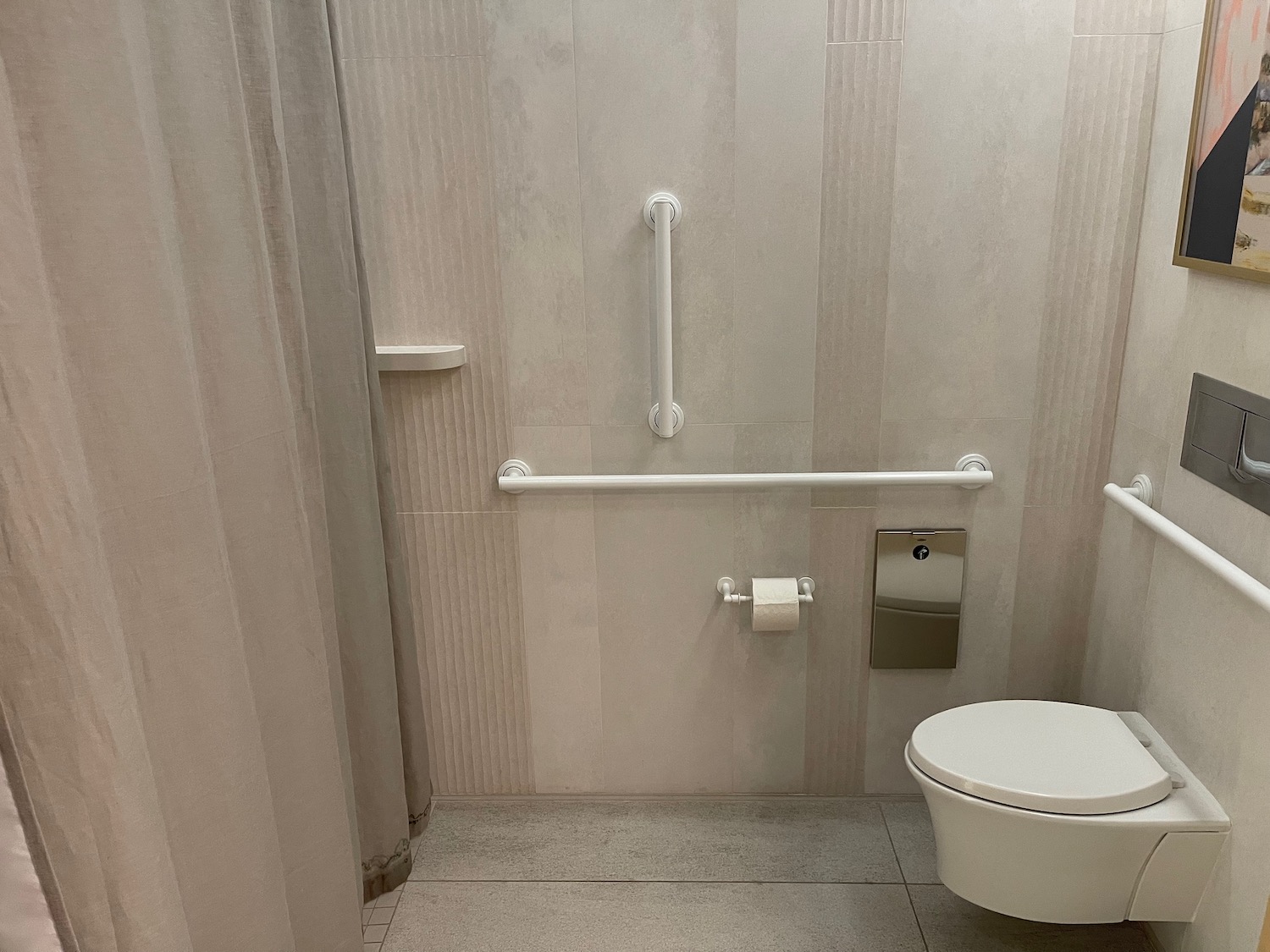 a bathroom with a toilet and a grab bar