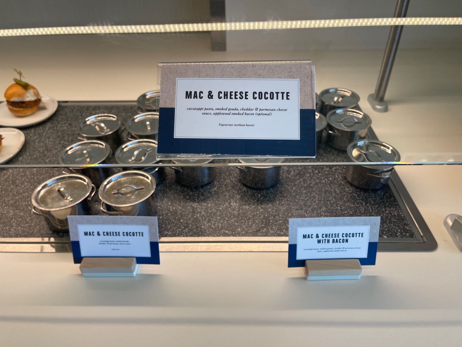 a group of silver cans with a sign on a glass case