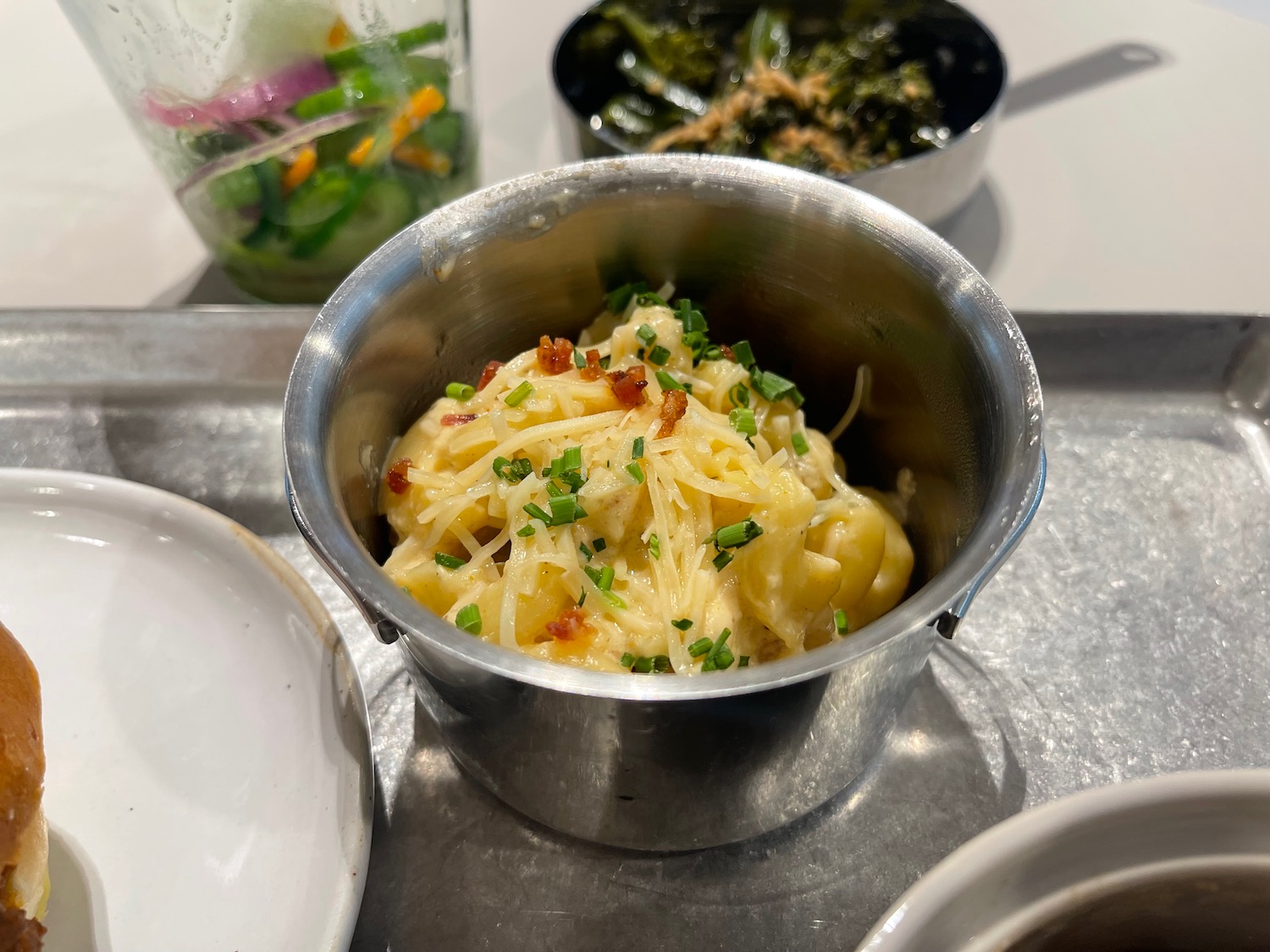 a bowl of pasta with bacon and green onions