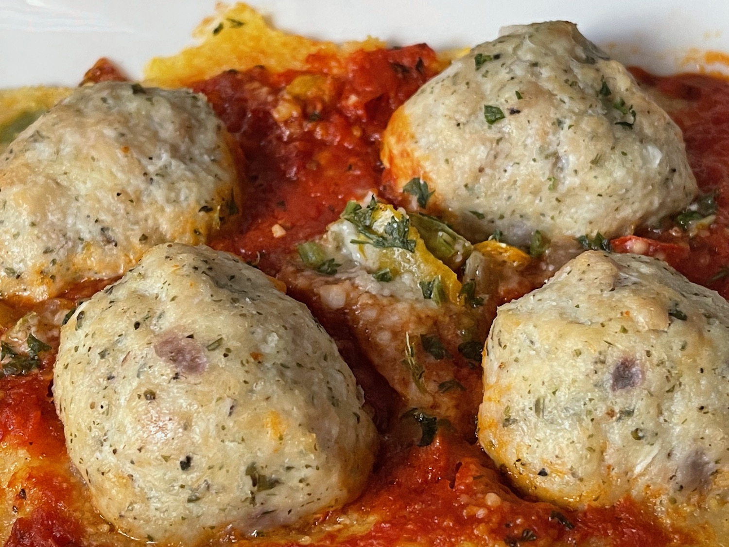 a plate of food with meatballs and sauce