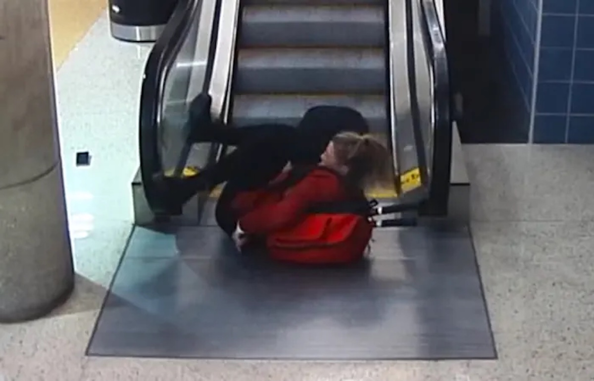 a person sitting on an escalator