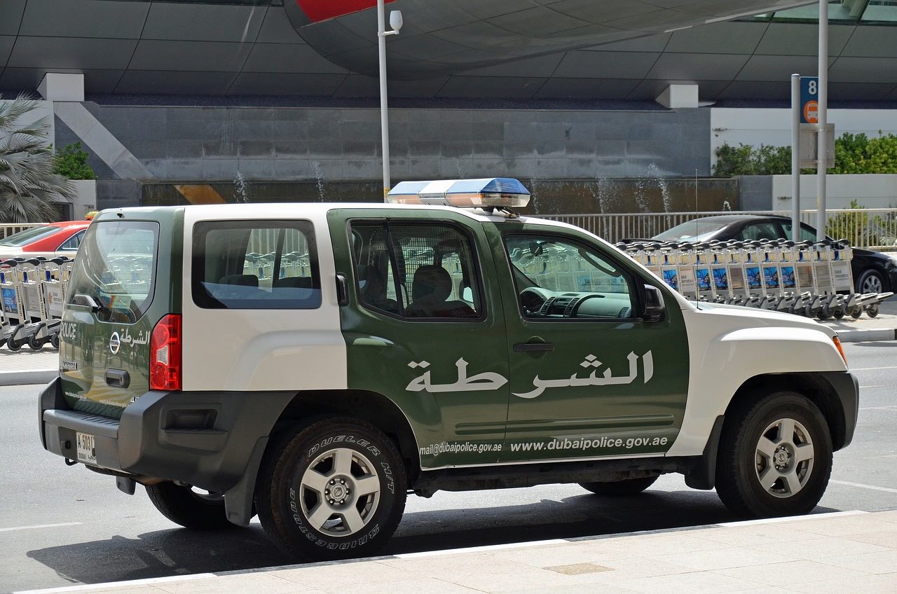 a green and white vehicle with a light on the side