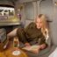a woman reading a book in a plane