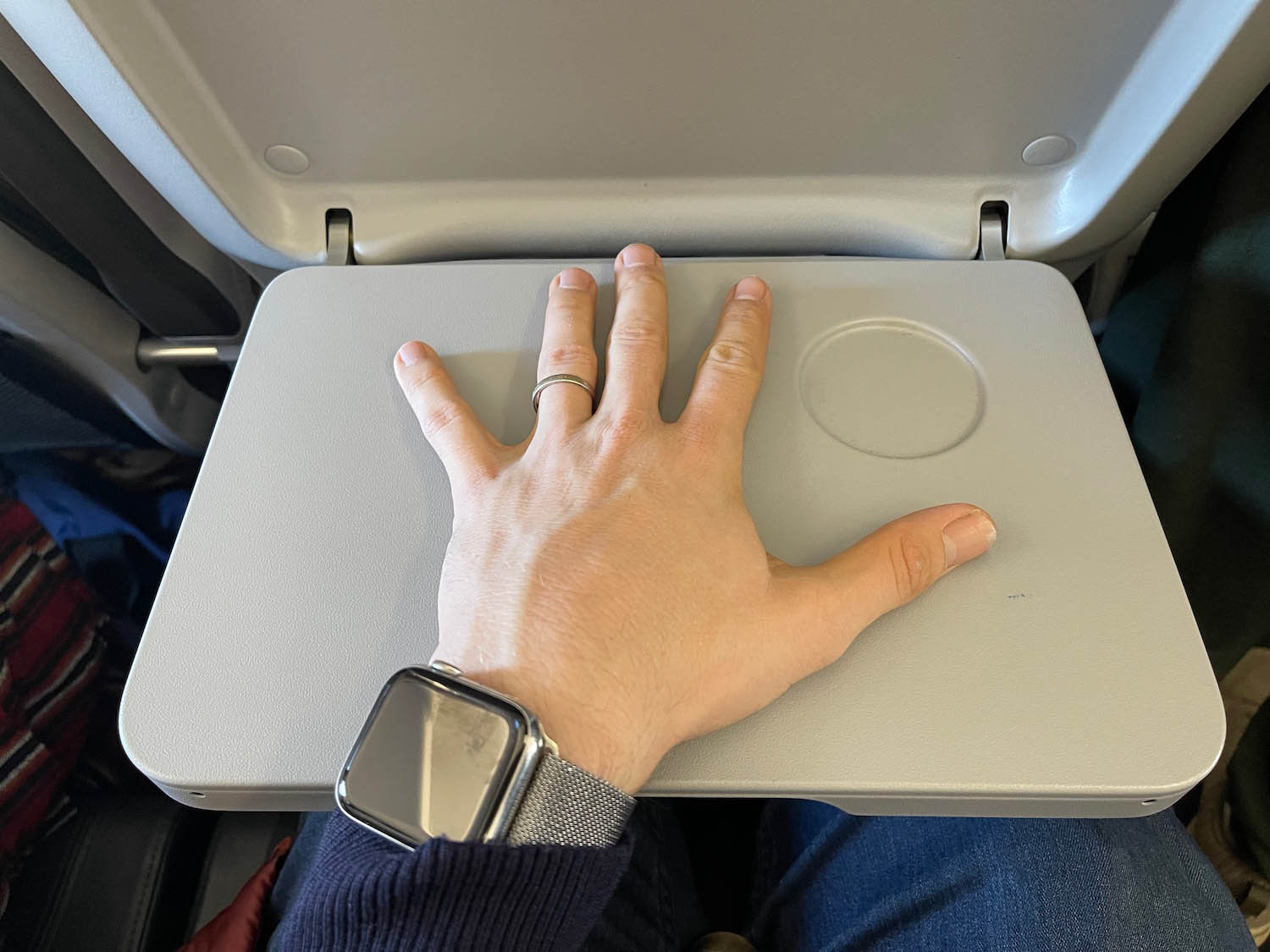 a hand on a grey tray