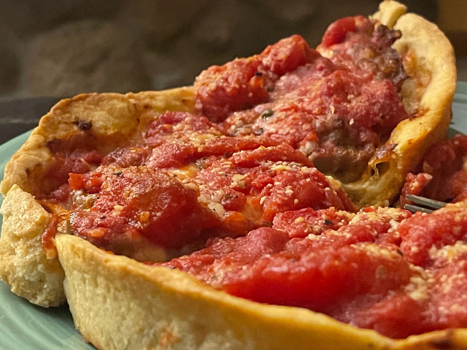 a deep dish pizza with red sauce