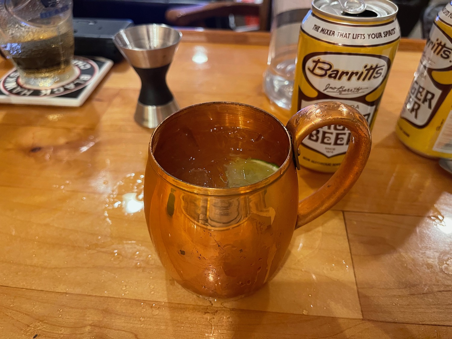 a copper mug with lime on a wooden surface