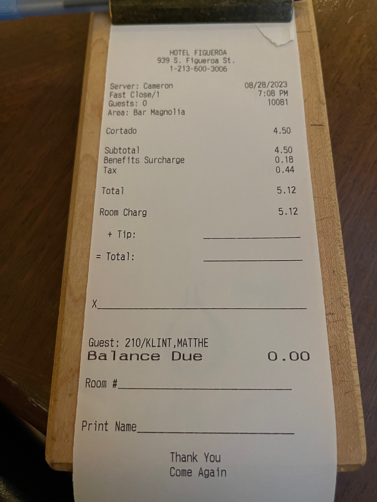 a receipt on a wood surface