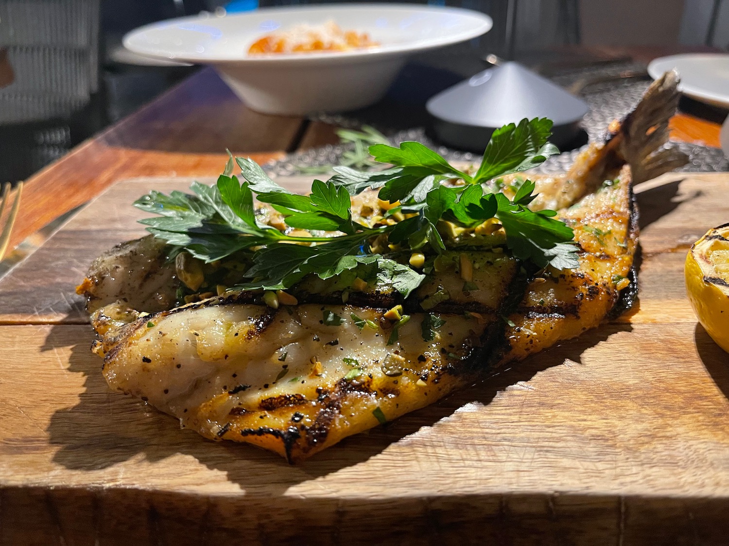 a piece of fish with parsley on top