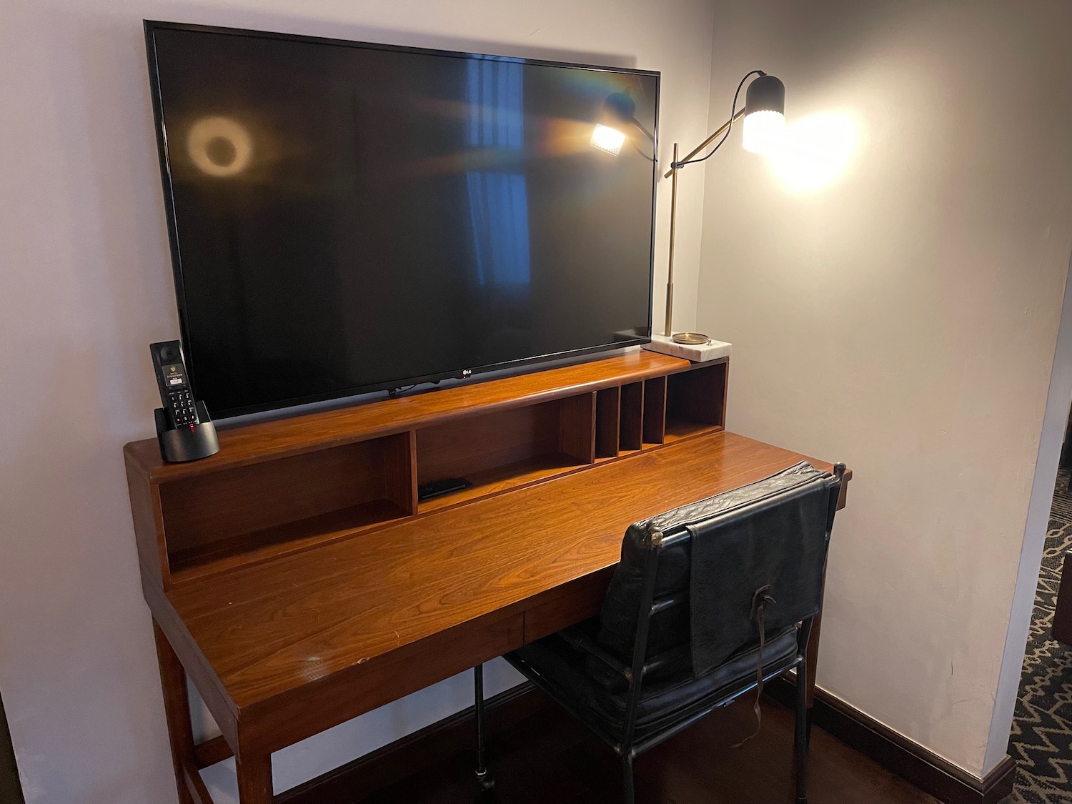 a desk with a large television on it