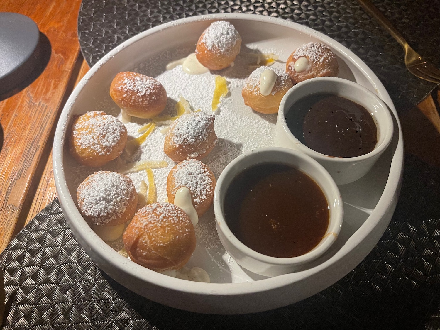 a plate of food with sauces and powdered sugar