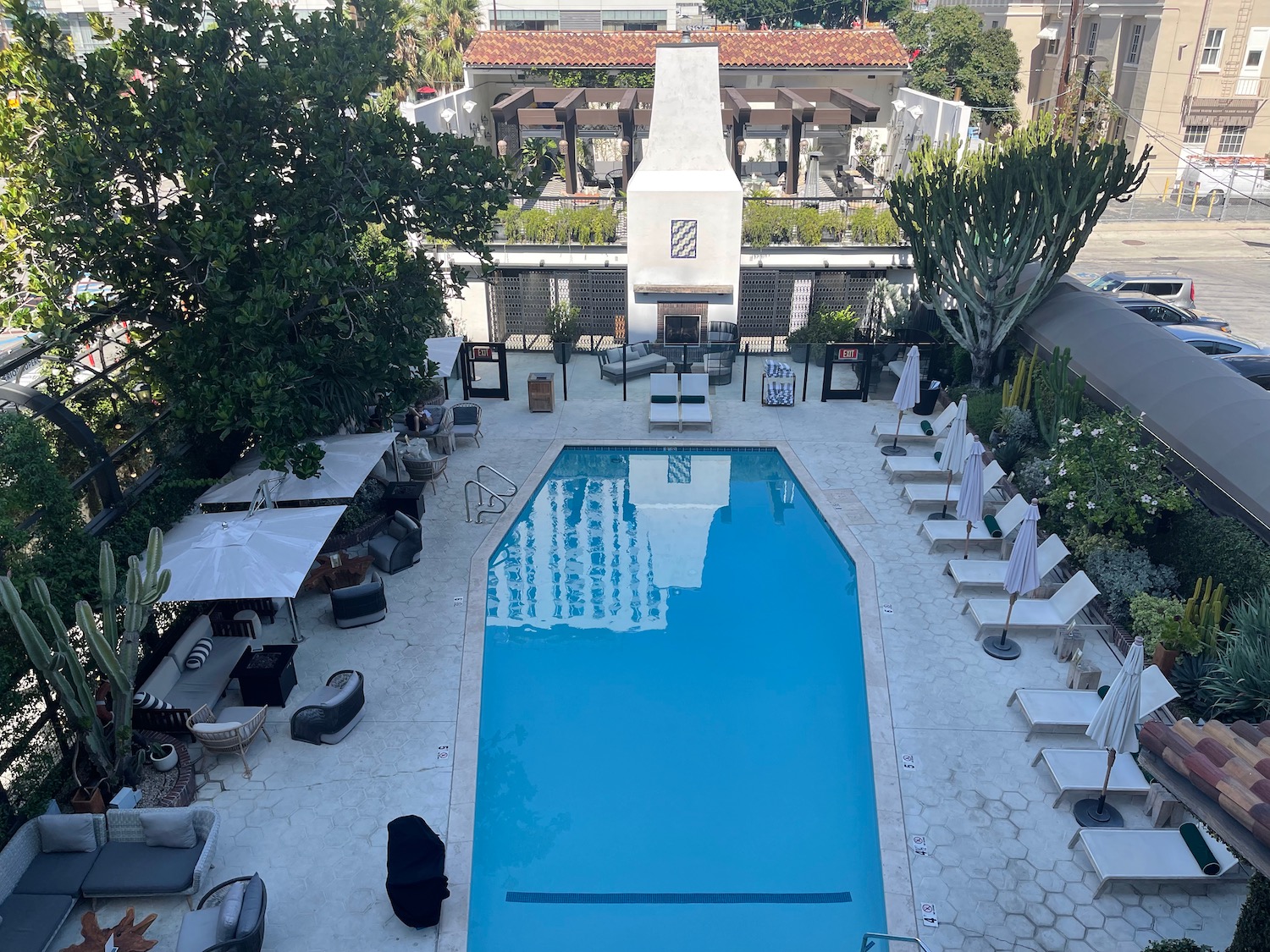 a swimming pool with chairs and a fireplace