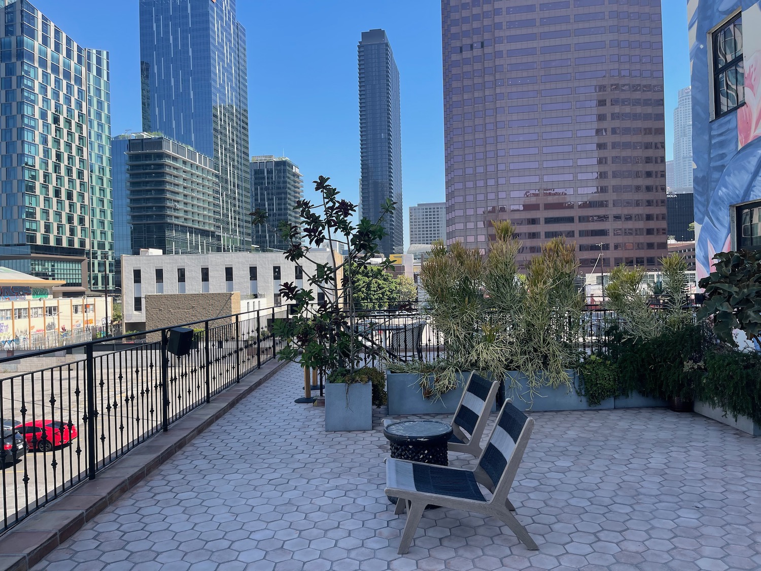 a bench on a rooftop with tall buildings in the background