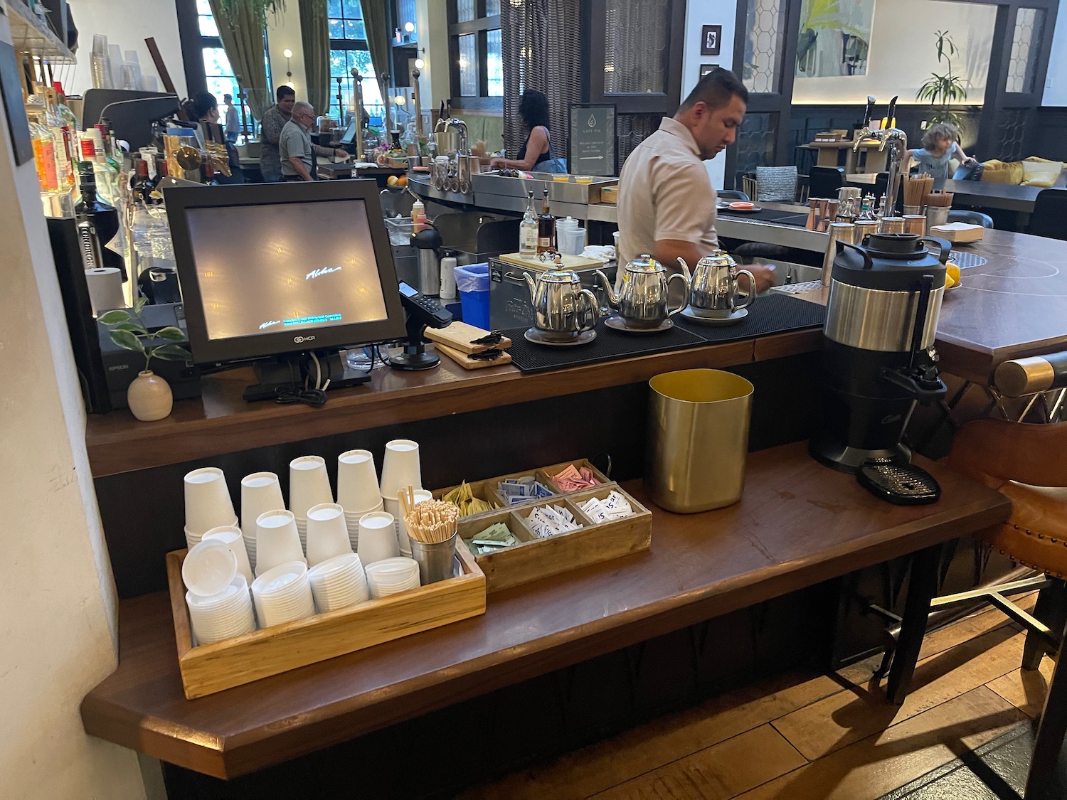 a man behind a counter in a restaurant