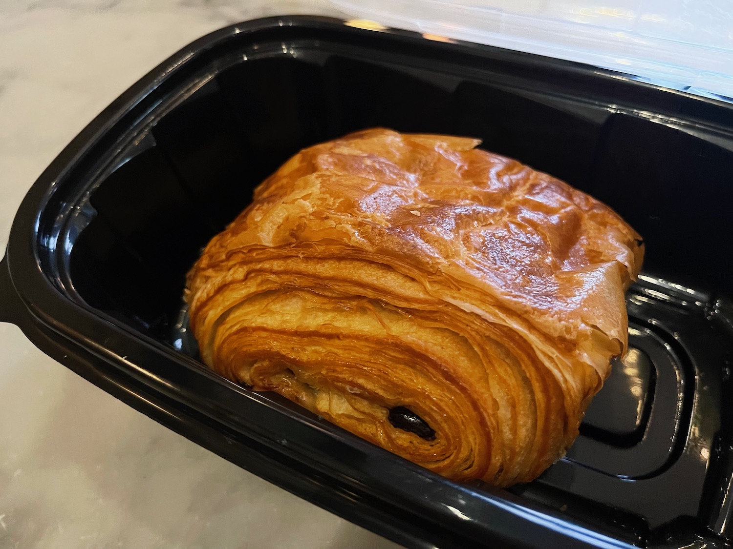 a pastry in a black container