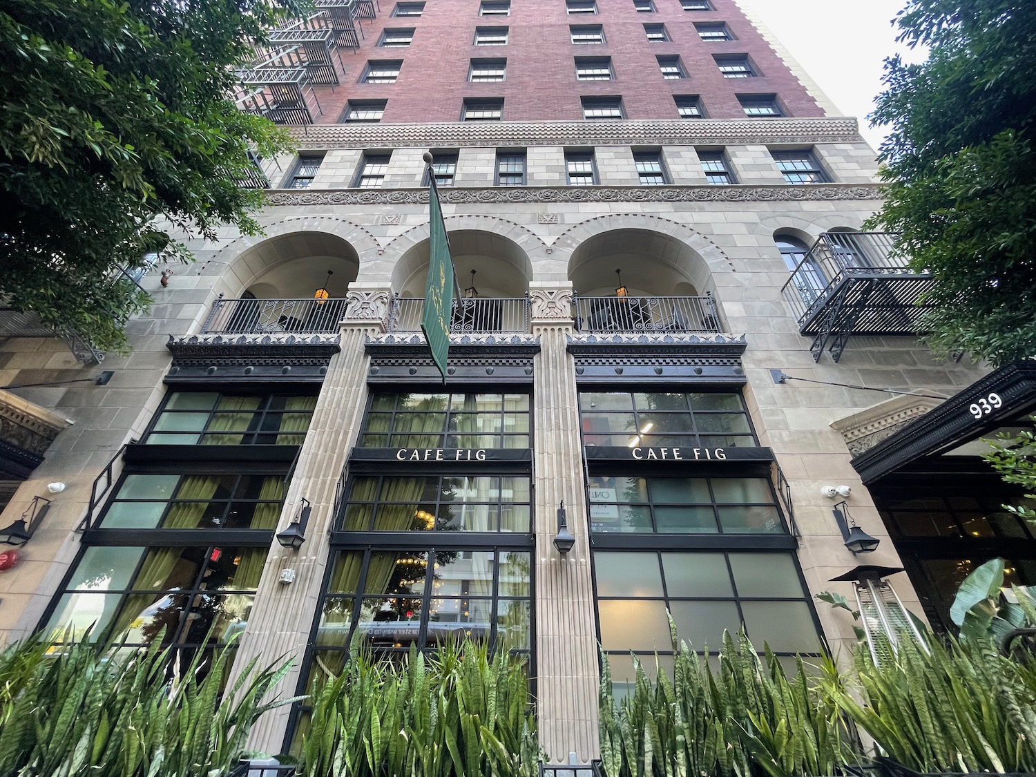 a building with a balcony and plants