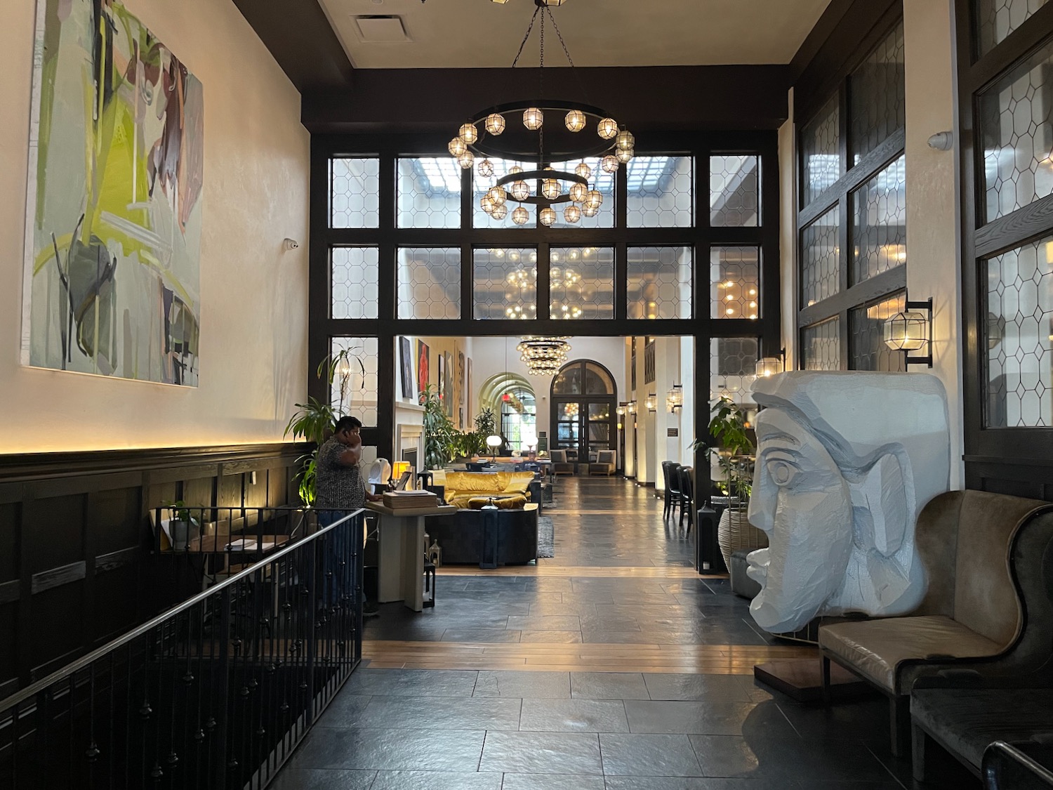 a large room with a large chandelier and a large statue